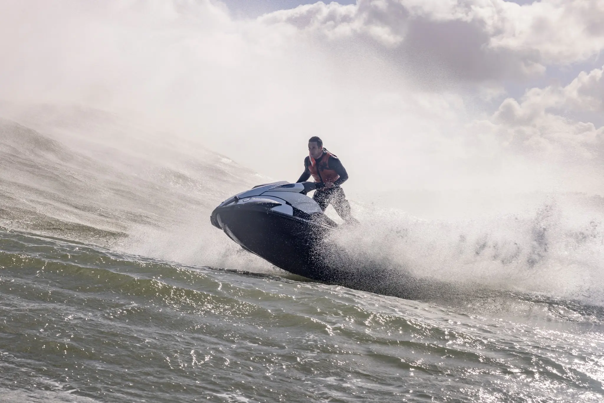 Ivo piloting a jet ski through ocean spray at Nazaré